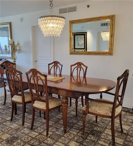 a view of a dining room with furniture and chandelier