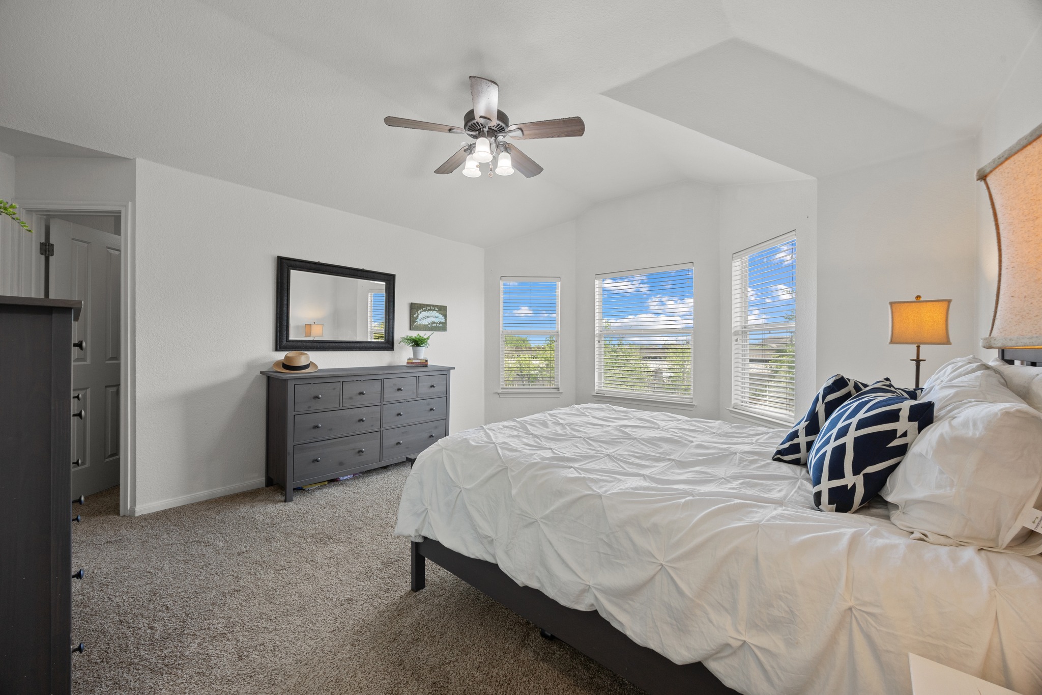 17833 Madden Drive Pflugerville, TX 78660 - Photo 12 of 21 a bedroom with a bed and a flat tv screen on dresser