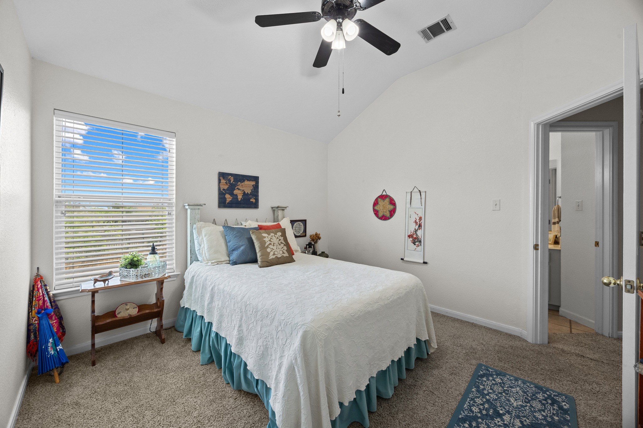 17833 Madden Drive Pflugerville, TX 78660 - Photo 14 of 21 a bedroom with a bed and a chandelier