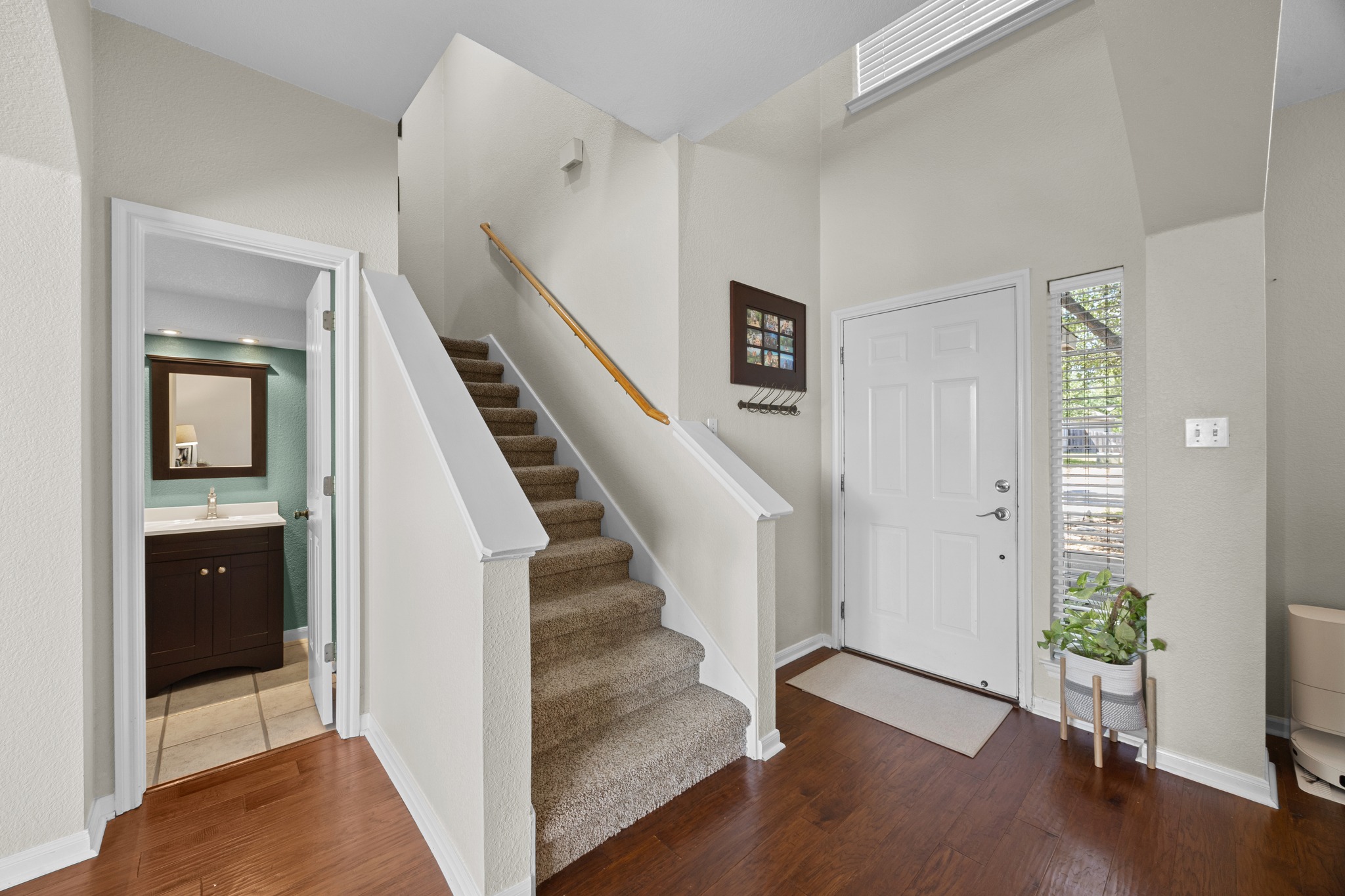 17833 Madden Drive Pflugerville, TX 78660 - Photo 9 of 21 a view of a hallway with wooden floor and entryway
