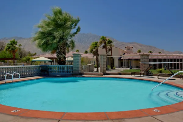 a view of a house with swimming pool and porch