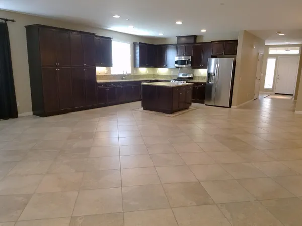 a kitchen with stainless steel appliances granite countertop a refrigerator and a sink