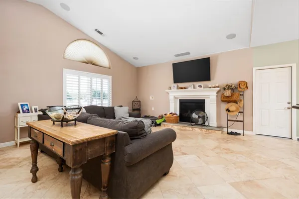 a living room with furniture a fireplace and a flat screen tv