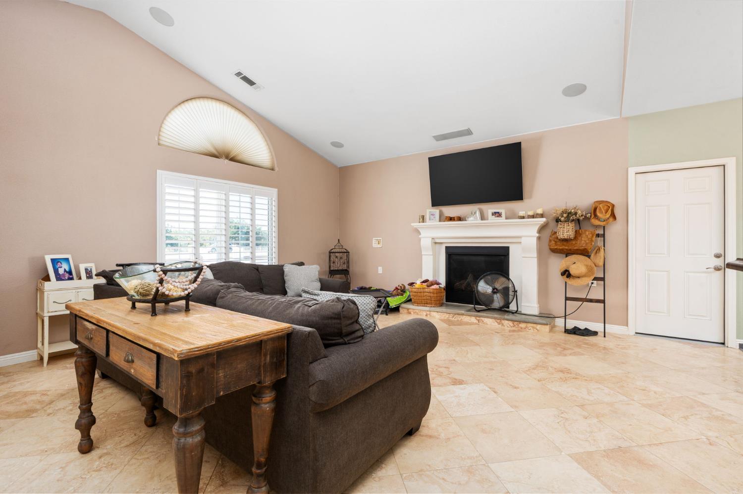 28565 Ave 21 Madera, CA 93638 - Photo 12 of 46 a living room with furniture a flat screen tv and a fireplace