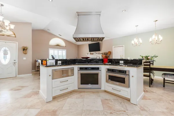 a kitchen with stainless steel appliances a stove a sink and a microwave