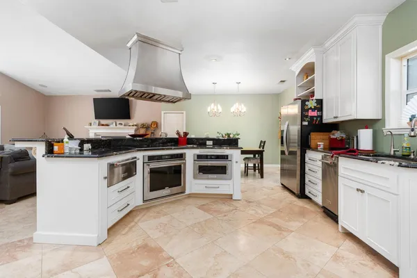 a kitchen with cabinets appliances and a counter top space