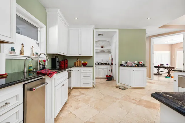 a kitchen with stainless steel appliances a refrigerator sink and cabinets