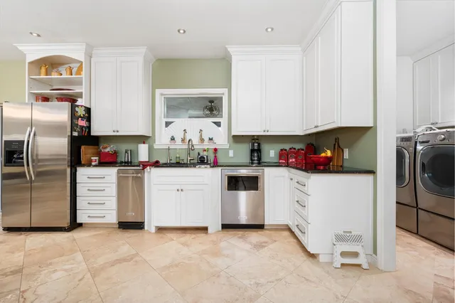 a living room with kitchen island granite countertop furniture and a view of kitchen