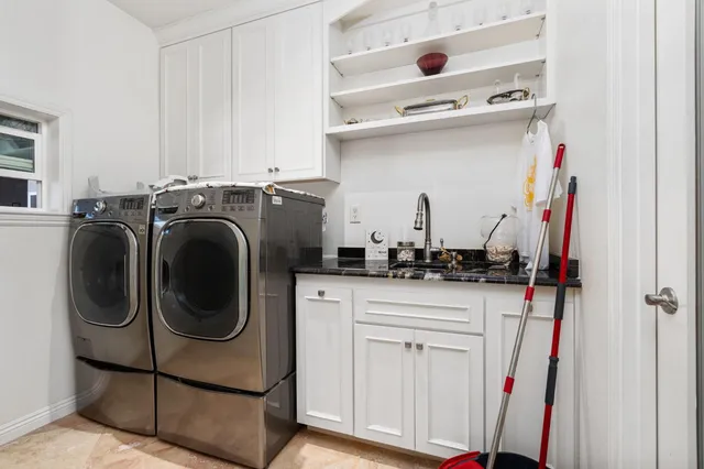 a bathroom with a double vanity sink toilet and shower