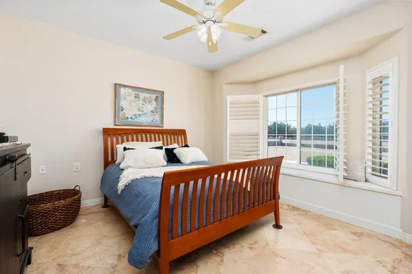 a spacious bedroom with a bed and a couch