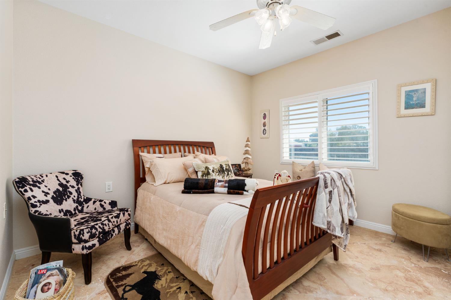 28565 Ave 21 Madera, CA 93638 - Photo 26 of 46 a spacious bedroom with a bed and a couch