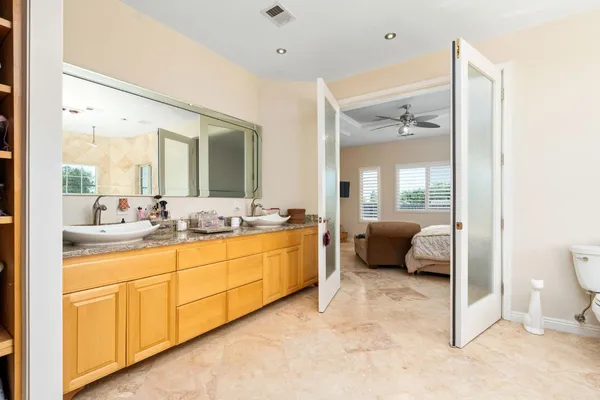 a spacious bathroom with a double vanity sink and a mirror