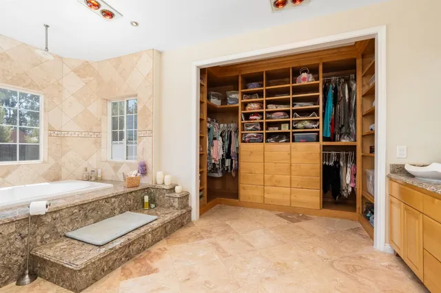 a spacious bedroom with a bed and a large window