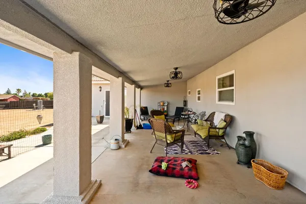 a living room with furniture and a floor to ceiling window