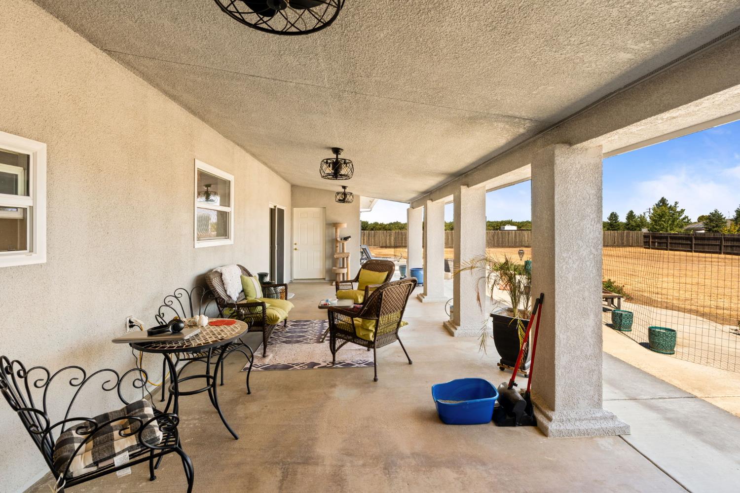 28565 Ave 21 Madera, CA 93638 - Photo 34 of 46 a living room with furniture and a floor to ceiling window