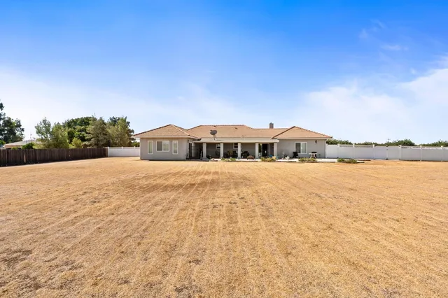 a front view of a house with yard and balcony