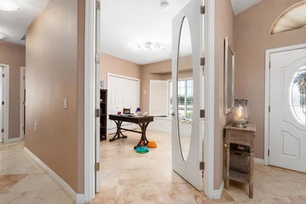 a living room with furniture and a book shelf