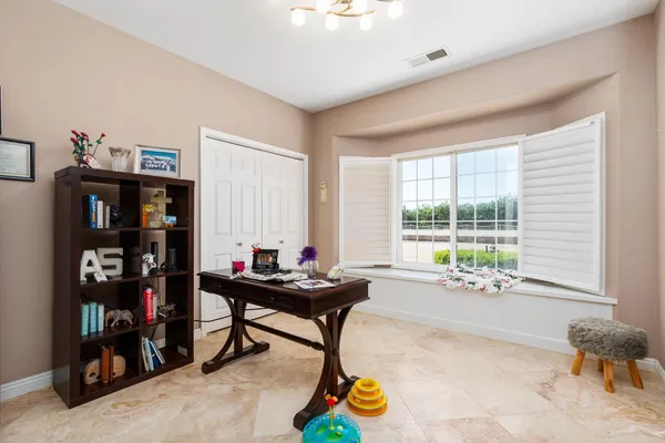 a living room with furniture and kitchen view