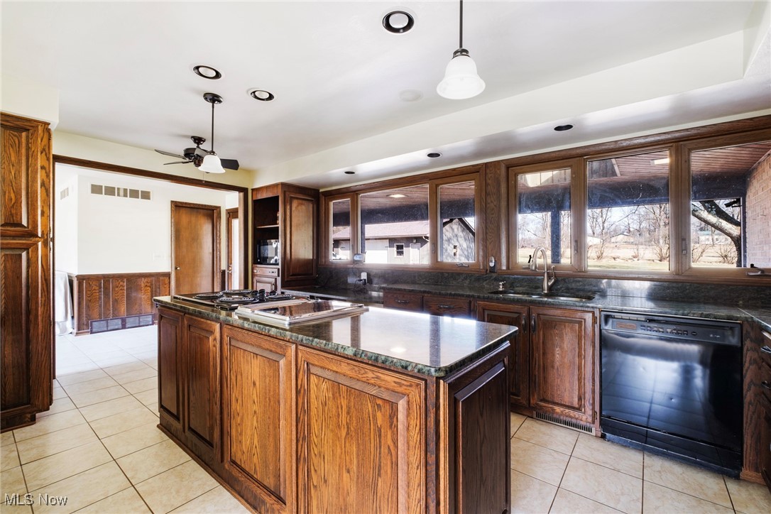 7059 Stewart Sharon Road Hubbard, OH 44425 - Photo 18 of 49 Kitchen featuring a kitchen island, black dishwasher, light tile patterned flooring, a ceiling fan, and a sink