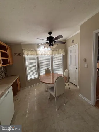 a living room with furniture a window and a flat screen tv