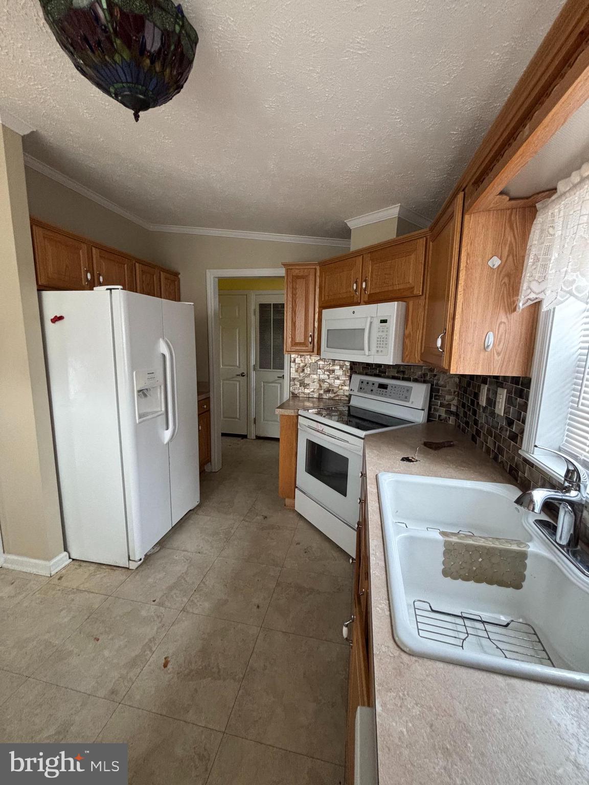511 Sykesville Road, Unit 16 Wrightstown, NJ 08562 - Photo 5 of 12 a kitchen with stainless steel appliances a stove a microwave a sink a refrigerator and cabinets