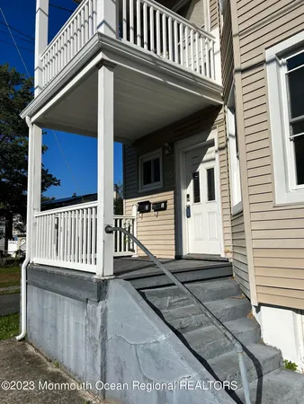 a view of a house with wooden fence