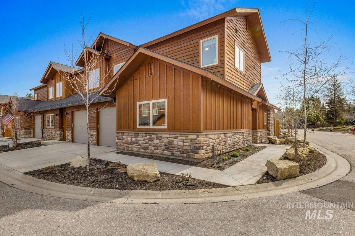 609 Blue Water Circle McCall, ID 83638 - Photo 2 of 45 View of side of home featuring stone siding, board and batten siding, and driveway