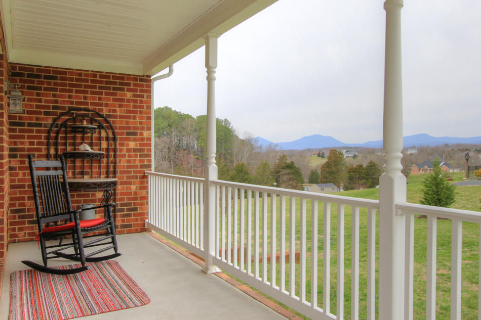 208 Longhill Road Goode, VA 24556 - Photo 2 of 59 a view of a balcony with wooden floor next to a road