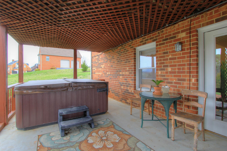 208 Longhill Road Goode, VA 24556 - Photo 13 of 59 a view of a patio with a table and chairs
