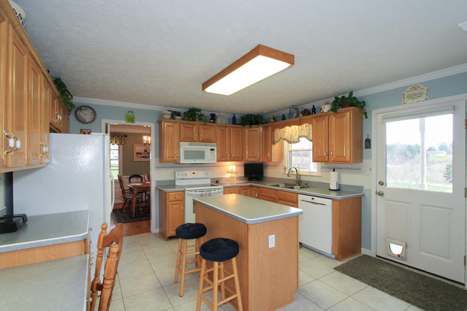 208 Longhill Road Goode, VA 24556 - Photo 23 of 59 a kitchen with a sink stove and refrigerator