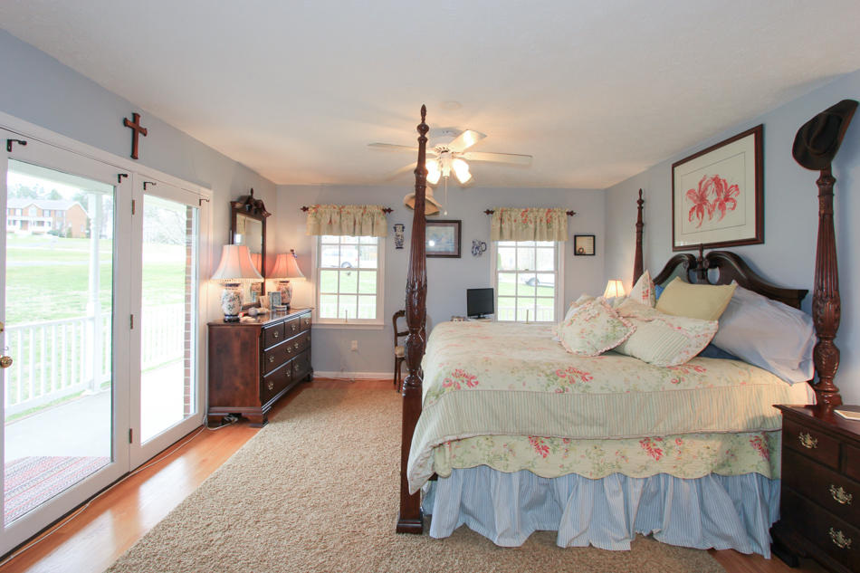 208 Longhill Road Goode, VA 24556 - Photo 29 of 59 a bedroom with a bed and a large window