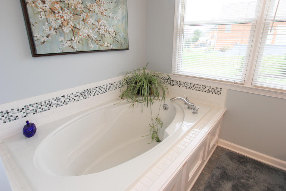 208 Longhill Road Goode, VA 24556 - Photo 32 of 59 a bathroom with a tub and a window