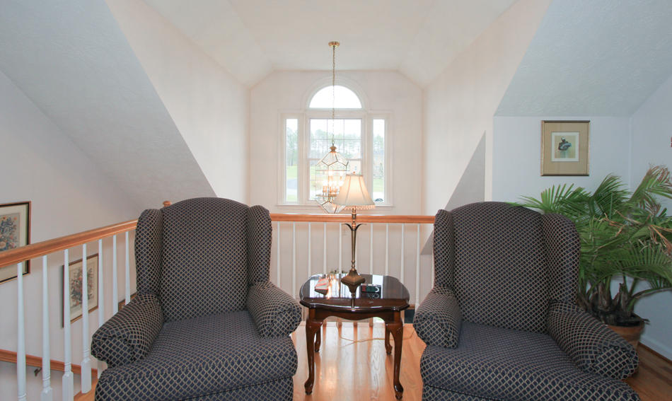 208 Longhill Road Goode, VA 24556 - Photo 40 of 59 a living room with furniture a chandelier and a window