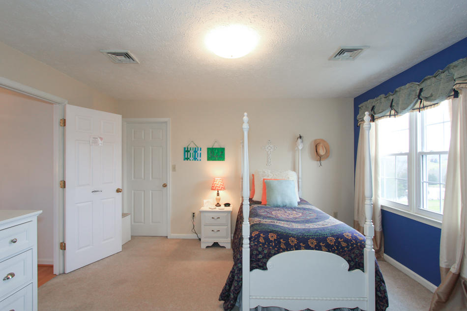 208 Longhill Road Goode, VA 24556 - Photo 48 of 59 a bedroom with a bed and wooden floor