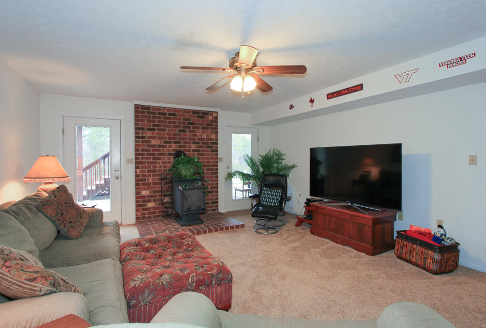 208 Longhill Road Goode, VA 24556 - Photo 51 of 59 a living room with furniture and a flat screen tv