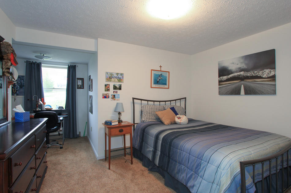 208 Longhill Road Goode, VA 24556 - Photo 54 of 59 a bedroom with a bed and a workspace