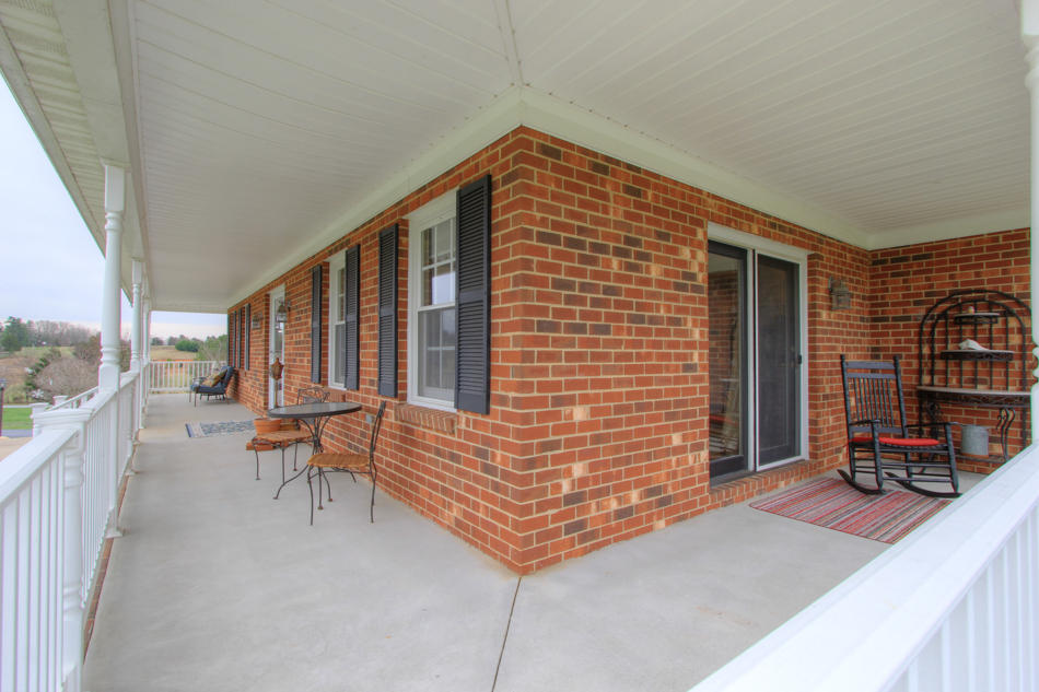 208 Longhill Road Goode, VA 24556 - Photo 8 of 59 a backyard of a house with barbeque oven table and chairs