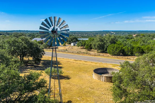 an aerial view of residential houses with outdoor space and swimming pool