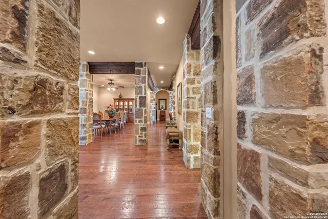 a living room with fireplace furniture and a wooden floor