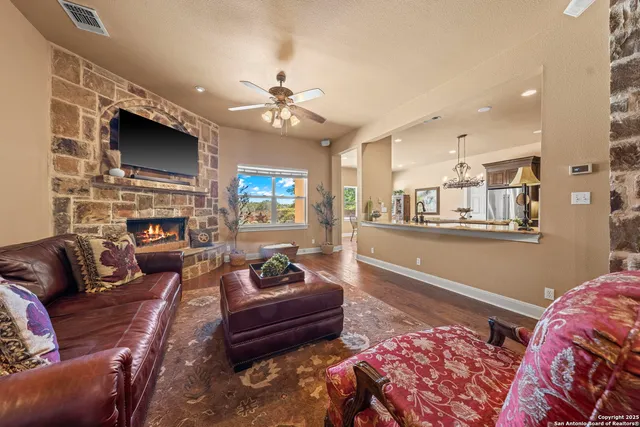 a kitchen with stainless steel appliances granite countertop a stove refrigerator and a dining table with wooden floor