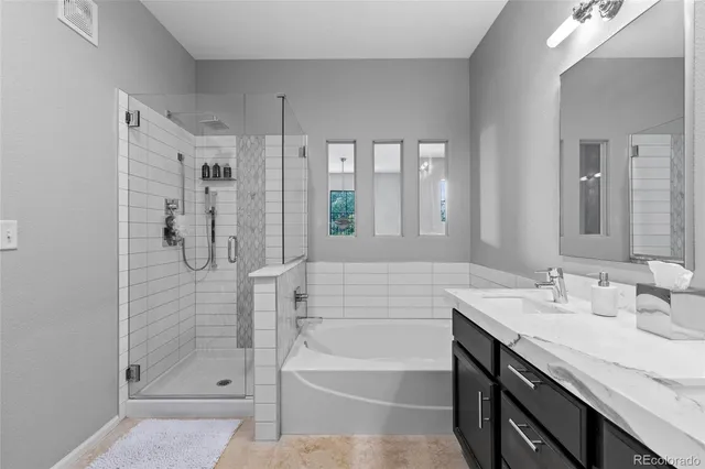 a bathroom with a granite countertop sink a shower and a mirror
