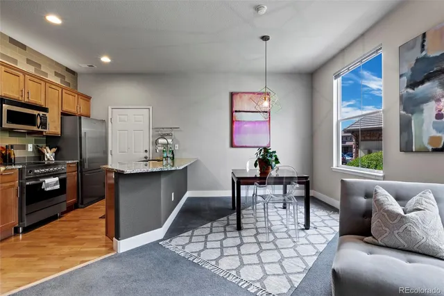 a living room with furniture a window and kitchen view