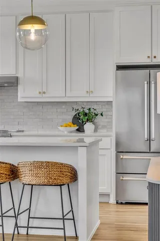 a kitchen with a refrigerator and cabinets