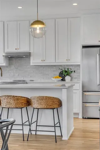 a kitchen with a table and chairs