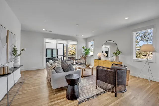 a living room with fireplace furniture and wooden floor