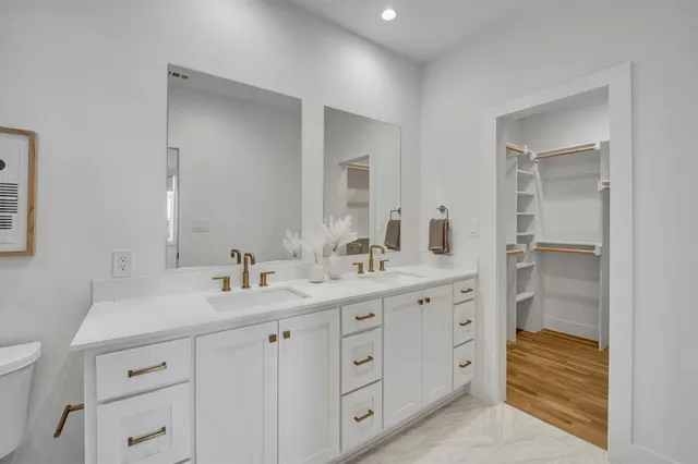 a bathroom with a double vanity sink and mirror