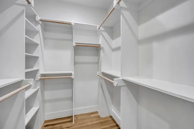 a view of walk in closet with empty racks