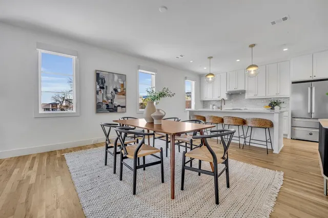 a view of a dining room with furniture and wooden floor