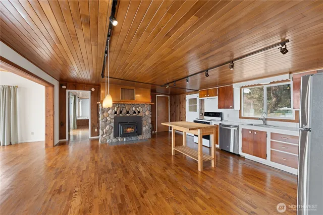 a large open kitchen with a table chairs and a wooden floor