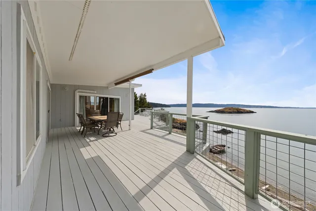 a view of roof deck with patio and wooden floor